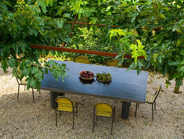 Garden still life with fruit bowls on a table