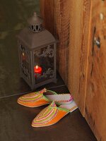 Moroccan slippers next to lantern
