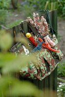 Gardening tools hanging at fence
