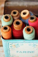Old spools of thread in tin box
