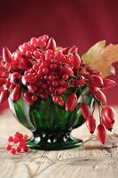 An autumnal bouquet of rose hips and snowball berries