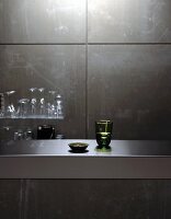 Glasses on stainless steel counter and glass shelf
