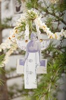 Nostalgic Christmas decoration made from old sheet music and popcorn garland on fir branches