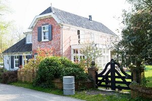 Renovierter und erweiterter Bauernhof als Wohnhaus mit Ziegelfassade und Garten