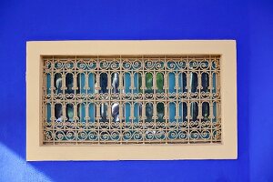 Oriental window in blue exterior wall