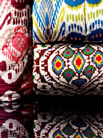 Rolled up blankets in a colourful mix of patterns
