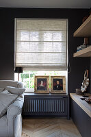 Living room detail with herringbone parquet flooring and pleated roller blind