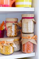 Storage jars with lids covered in brown paper