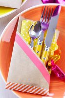 Hand-crafted kraft paper cutlery pocket stuck together with washi tape
