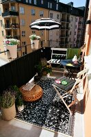 Comfortable balcony with black and white accessories