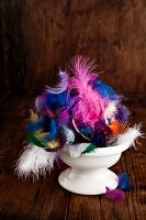 Easter arrangement of colourful feathers in bowl