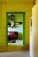 View from yellow hallway through green doorway into living area