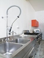 Küchenzeile aus Edelstahl mit moderner Armatur in loftartiger Küche