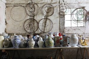 Collection of Chinese vases and lampshade frames in old workshop