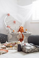 Indoor picnic with peacock chair, pouf and floor cushions in white and grey