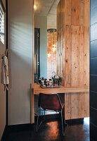 Wooden table in modern bathroom with hanging lamps