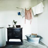 Antique cooker, washing line, zinc tub and washboard in utility room