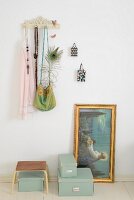 Vintage coat rack, vintage-style religious painting and storage boxes on floor