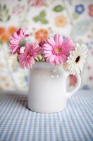 Flower arrangement of gerbera daisies in a mug