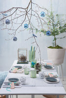 Festive table arrangement with decorated branch