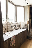 Cushions with buckles on window bench in window bay