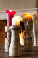 Partially used candles in wooden candlesticks