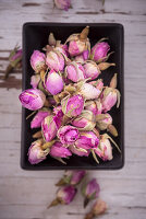 Dried rose buds in dish (top view)