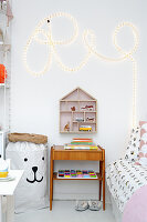 Word written with rope light and vintage furniture in child's bedroom