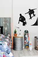 Silhouettes of skateboarders on wall of teenager's bedroom