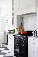 Gas cooker in black and white country-house kitchen