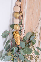 Festive wreath of eucalyptus leaves on wooden door