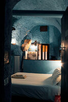 Rustic bedroom and ensuite bathroom with blue walls