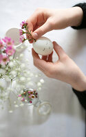 Arranging flowers in blown egg