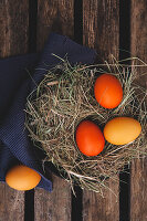 Easter eggs coloured with organic dyes in a nest