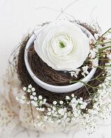 Delicate Easter arrangement with ranunculus and gypsophila