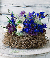 Iris, roses and alliums arranged in nest