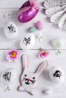 Easter eggs decorated with stickers, bunny biscuit and Easter decorations