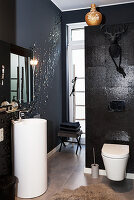 Glamorous black-and-white bathroom with pedestal sink
