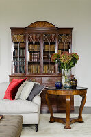 Regency bookcase behind marble-topped round table