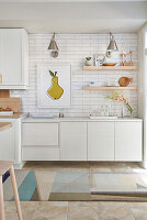 White kitchen with light wood accents and white subway tiles