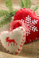 Small heart-shaped cushions decorated with moose and snowflake