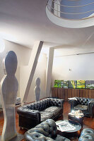 Leather sofa set and sculptures in loft apartment