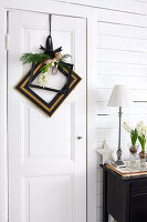 Old picture frames as a Christmas wreath on a white door