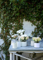 Screw-cap jars with paper cuffs with white roses and chrysanthemums