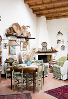 Small dining area and comfortable armchairs in front of a fireplace in a Mediterranean room