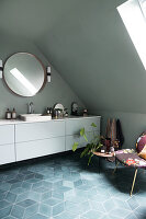 A long white vanity unit in an attic bathroom