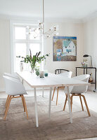 White lacquered wooden table with shell chairs