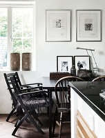 Black lacquered wooden table with chairs in the kitchen