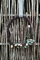 Wreath of birch twigs, wooden eggs and eucalyptus branches