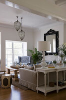 Sofa, armchairs and solid wooden table in seating area in front of fireplace